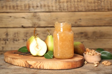 Delicious pear jam and fresh fruits on wooden table