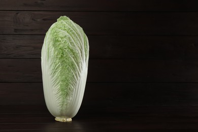 Photo of Fresh ripe Chinese cabbage on table against wooden background. Space for text