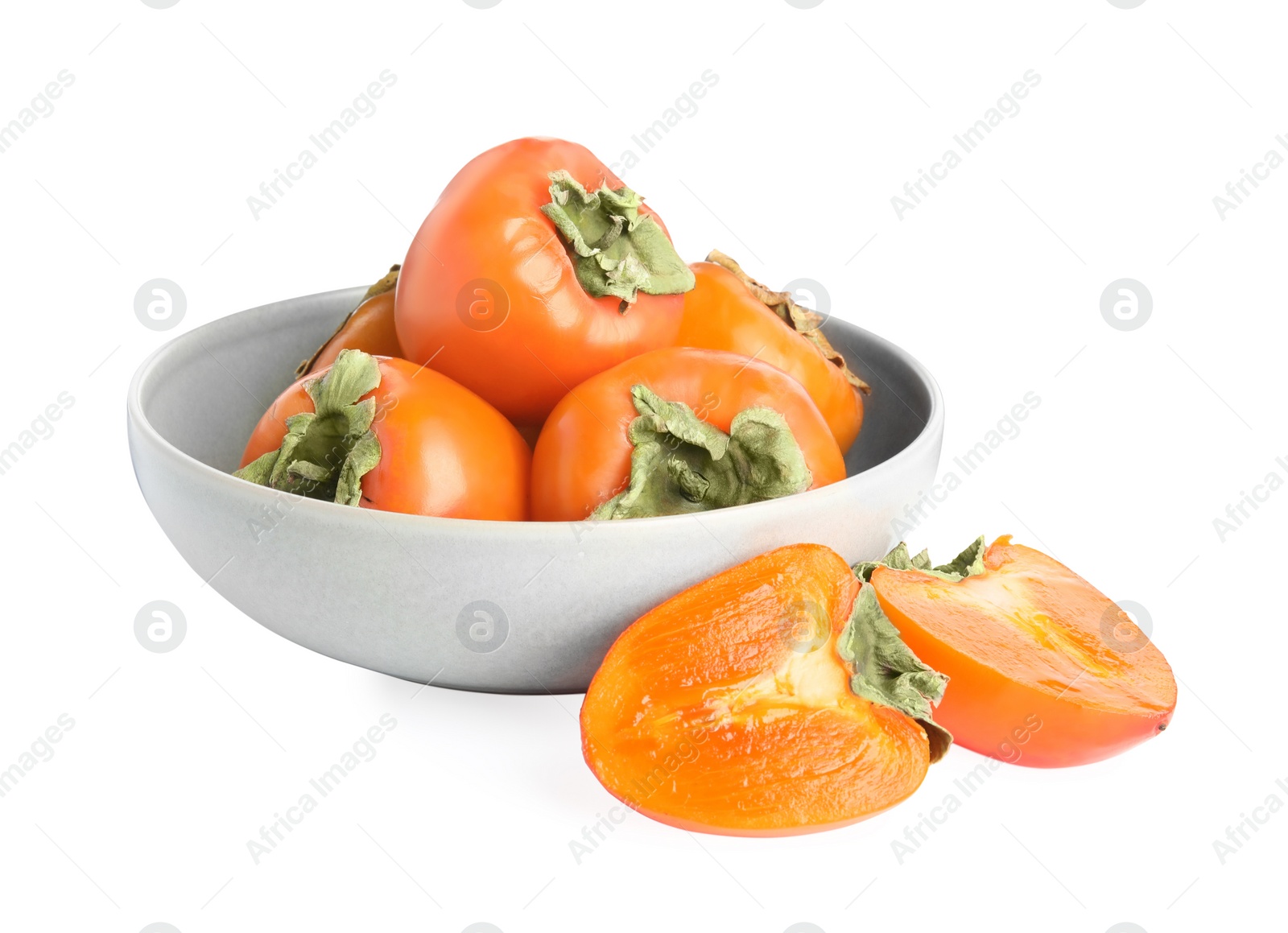 Photo of Bowl with delicious fresh persimmons isolated on white