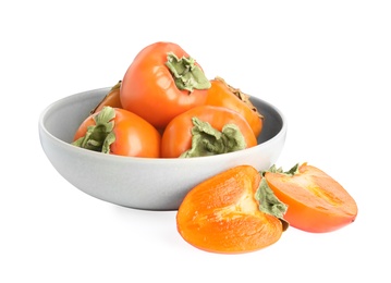 Photo of Bowl with delicious fresh persimmons isolated on white