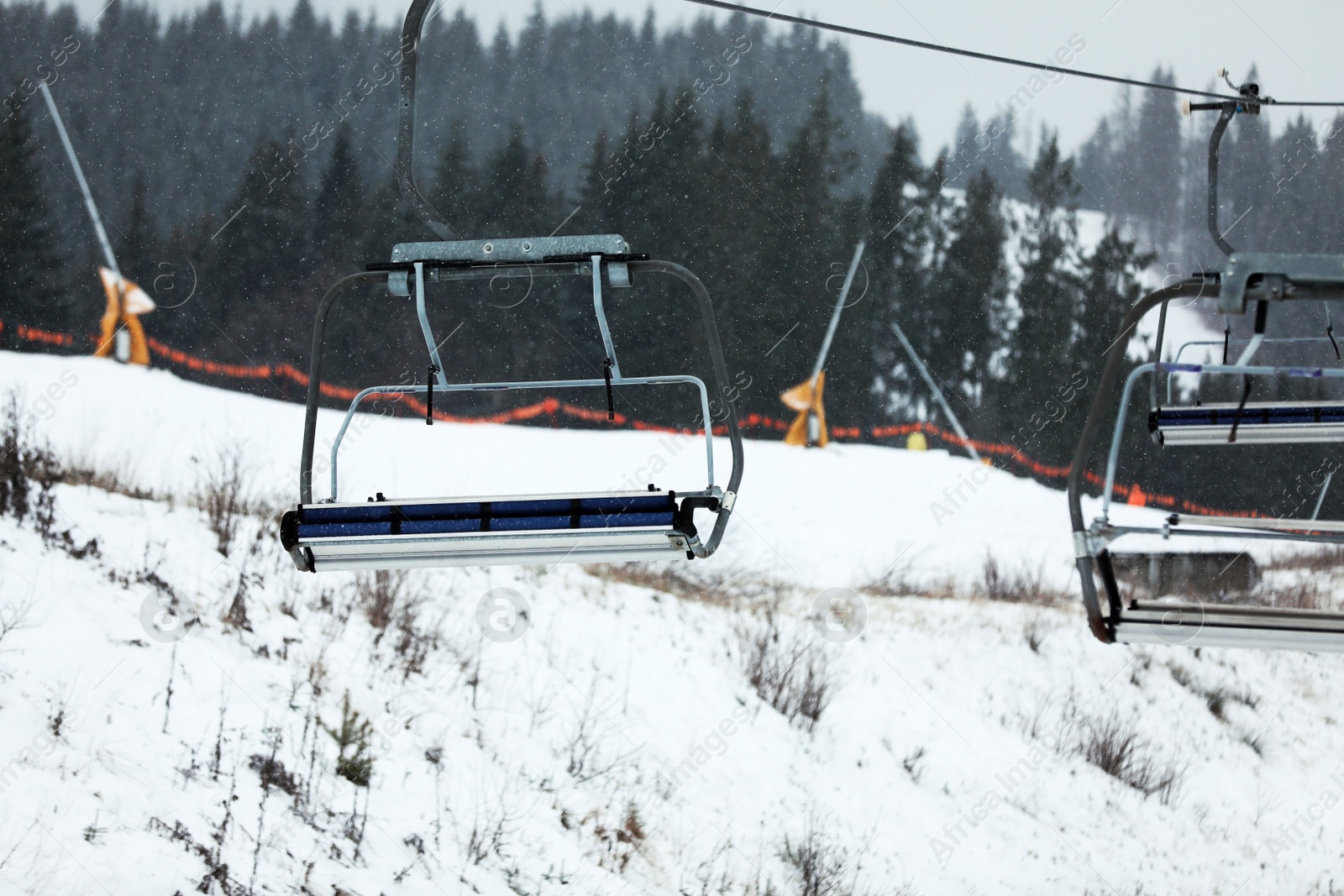 Photo of Empty chairlift at ski resort. Winter vacation