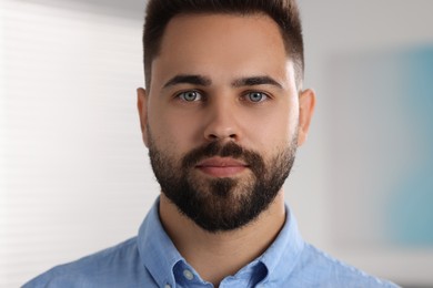 Portrait of young man on blurred background, closeup