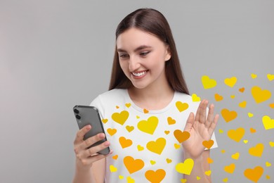 Long distance love. Woman chatting with sweetheart via smartphone on grey background. Hearts flying out of device