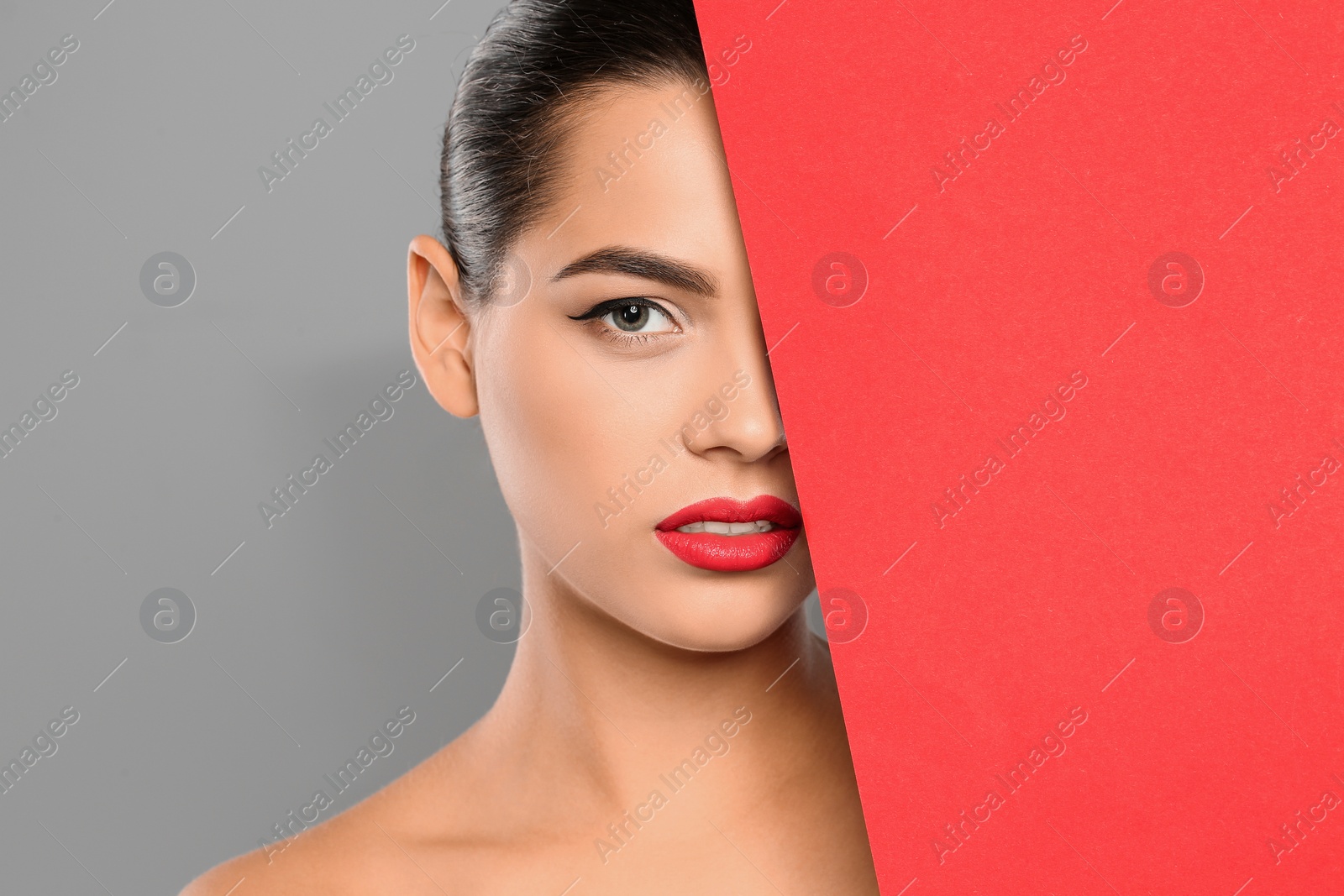 Photo of Young woman wearing beautiful lipstick on color background. Space for text