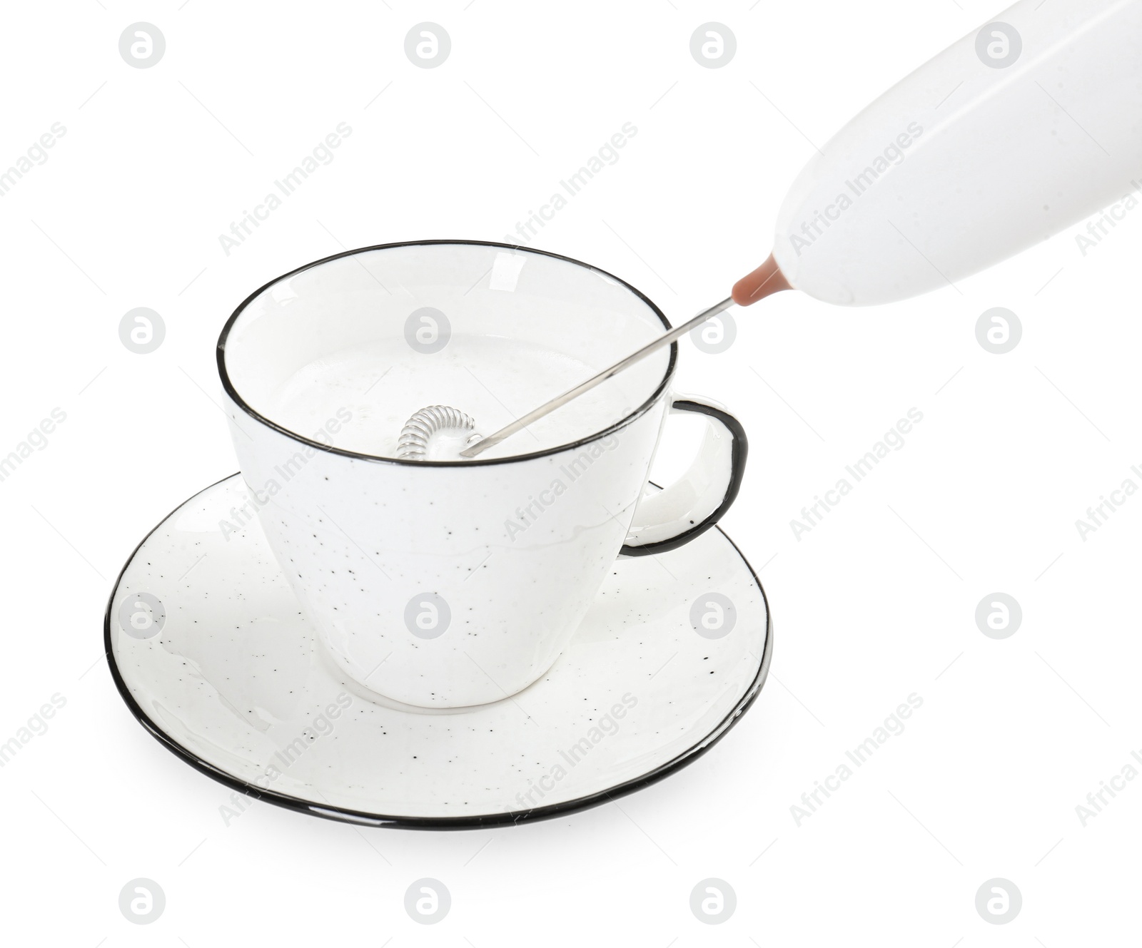 Photo of Whisking milk in cup with mini mixer (frother wand) isolated on white