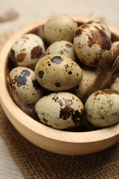 Photo of Speckled quail eggs on table, closeup view
