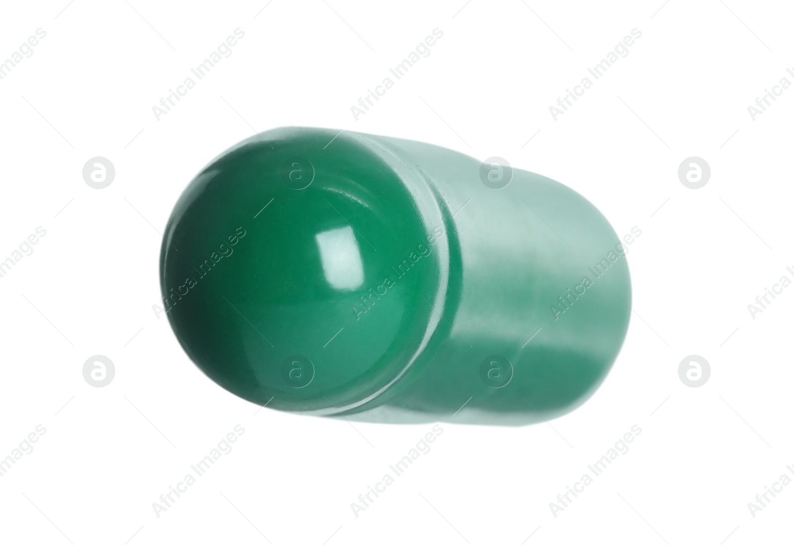 Photo of One green pill on white background. Medicinal treatment