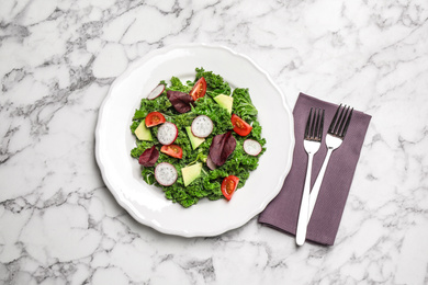 Photo of Delicious kale salad on marble table, flat lay