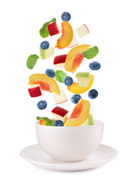 Image of Fresh tasty fruits and berries falling into bowl on white background