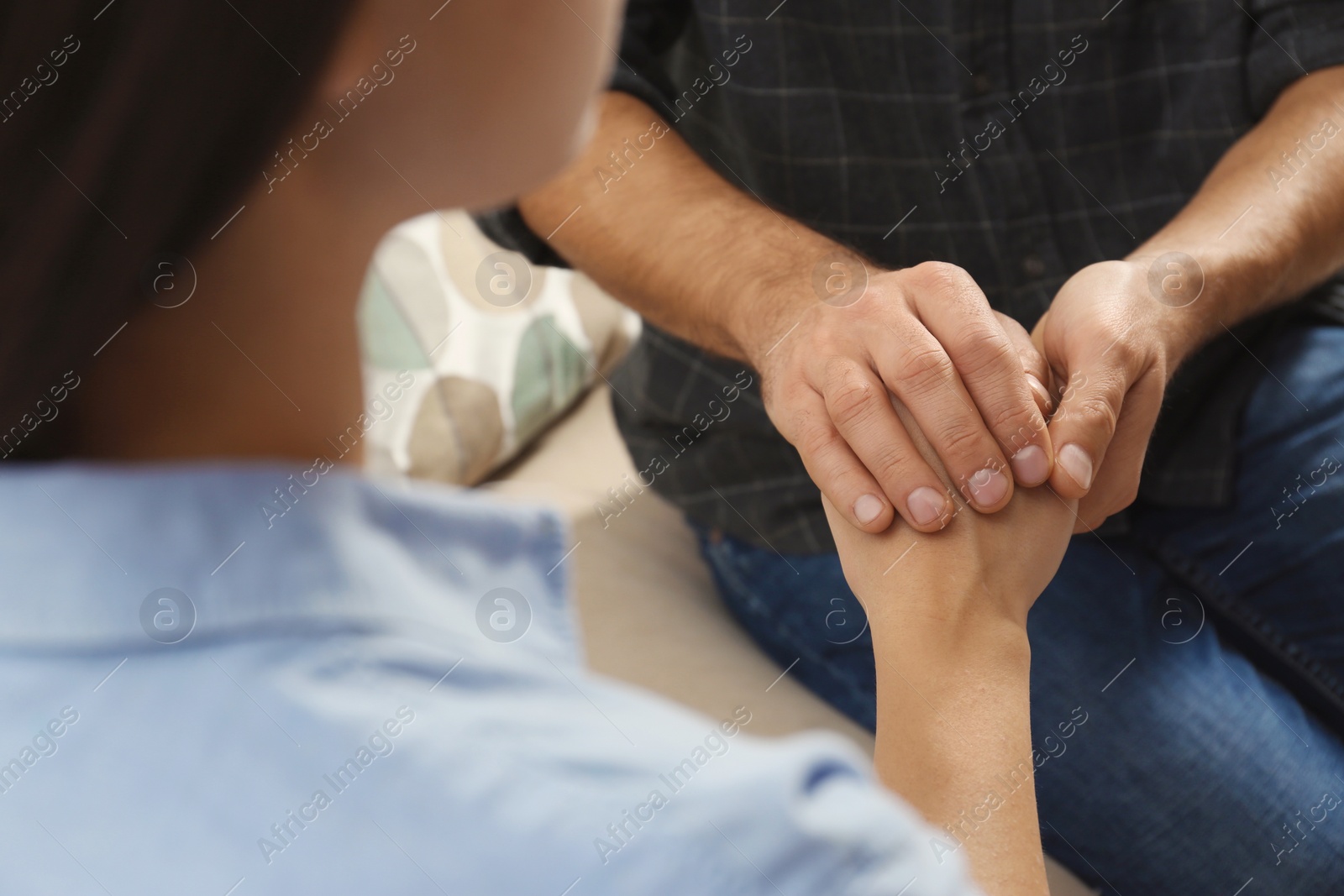 Photo of Man comforting woman, closeup of hands. Help and support concept