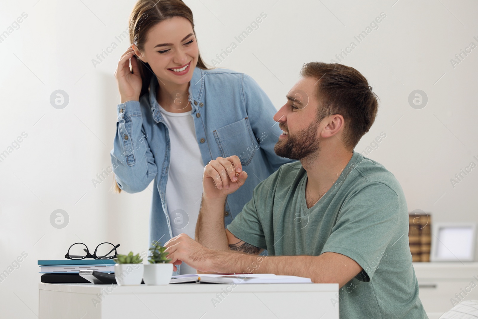 Photo of Young couple discussing family budget at home