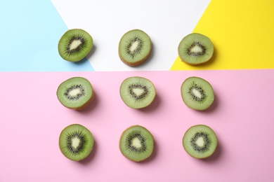 Top view of sliced fresh kiwis on color background