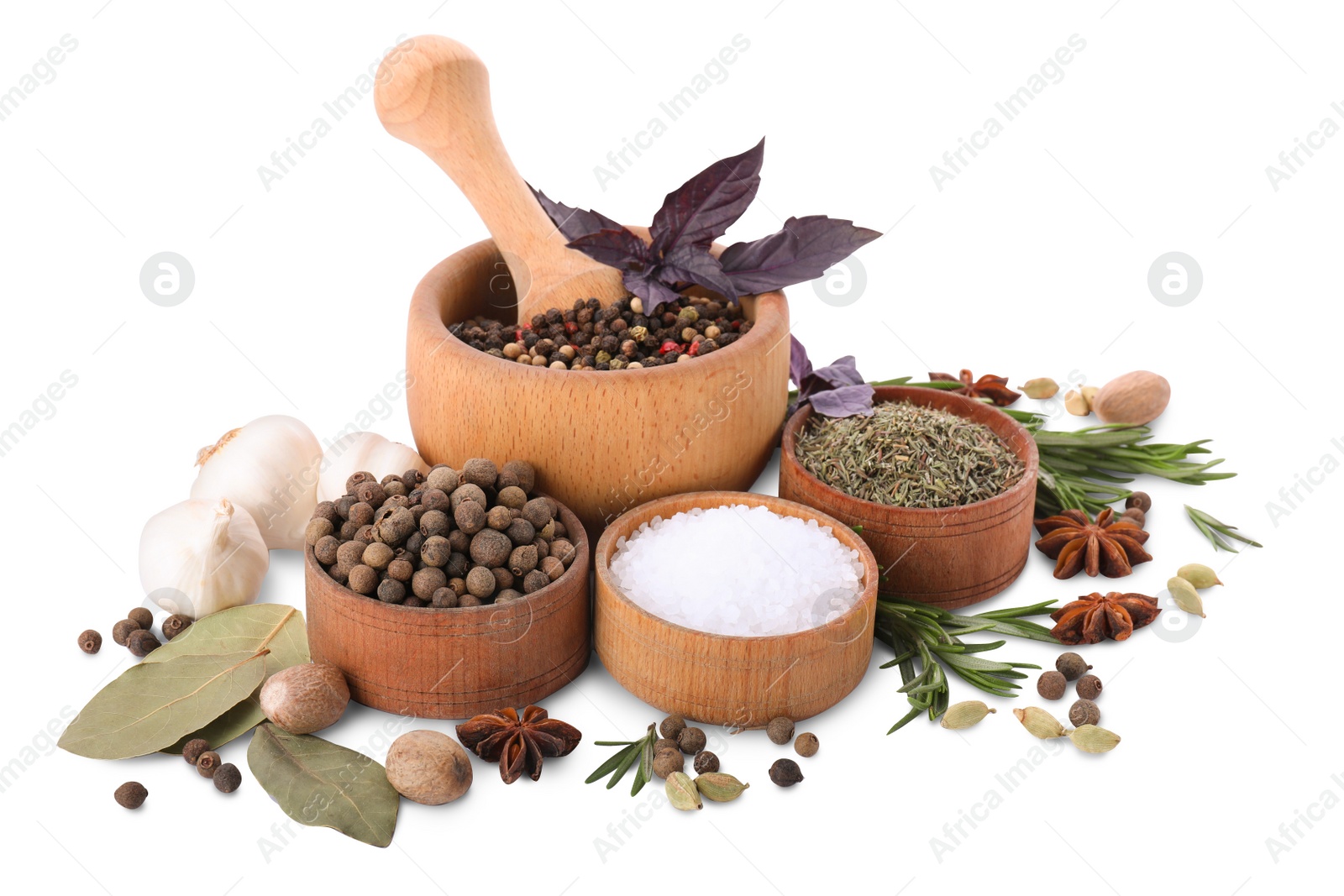 Photo of Mortar with pestle and different spices on white background