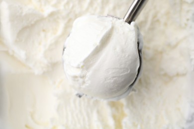 Photo of Steel scoop with tasty vanilla ice cream, top view