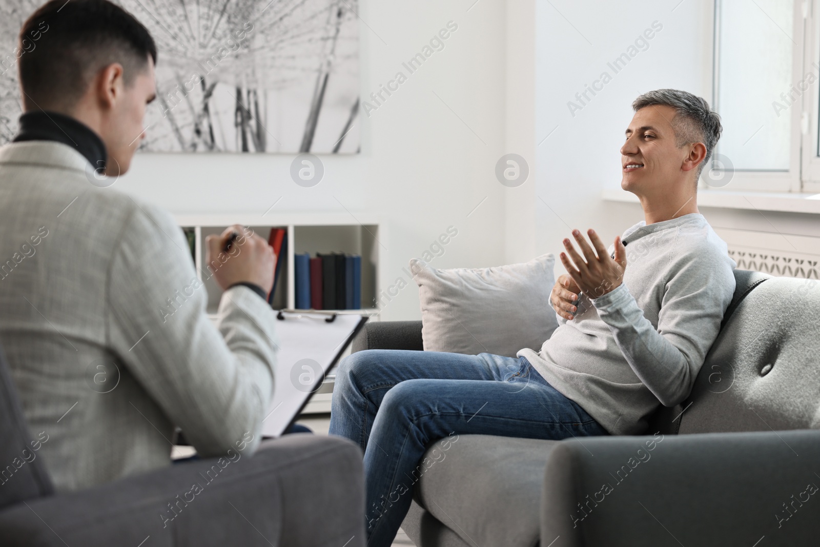 Photo of Professional psychotherapist working with patient in office