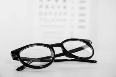 Glasses on light background, closeup. Ophthalmologist prescription