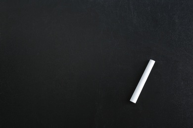 Photo of Piece of chalk on blackboard, top view