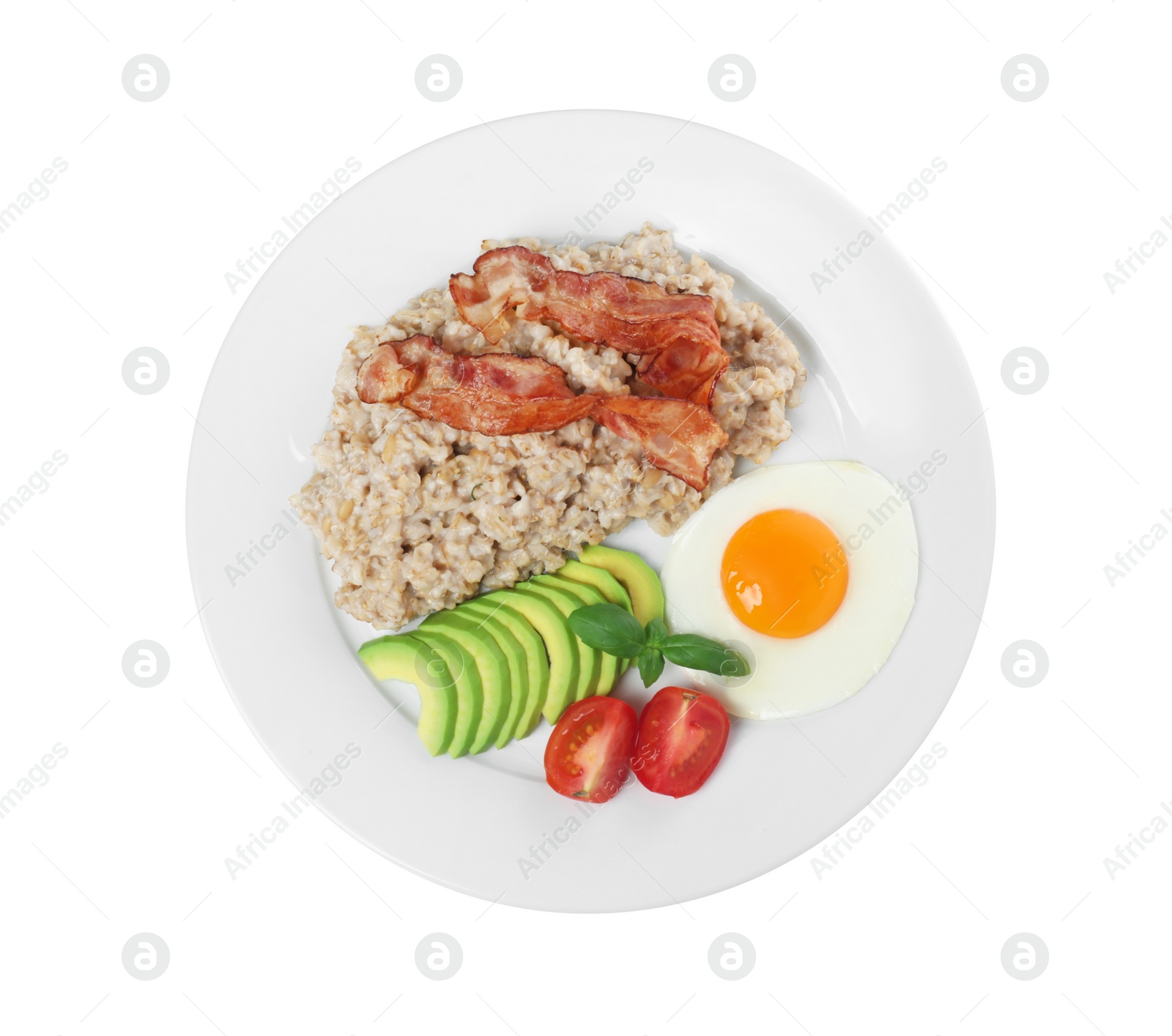 Photo of Delicious boiled oatmeal with fried egg, bacon, avocado and tomato isolated on white, top view