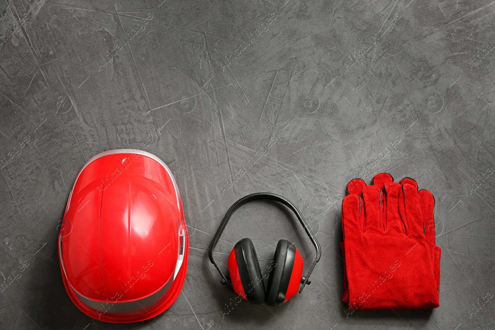 Photo of Flat lay composition with safety equipment and space for text on grey background