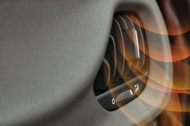 Closeup view of conditioning system in car and illustration of warm air flow