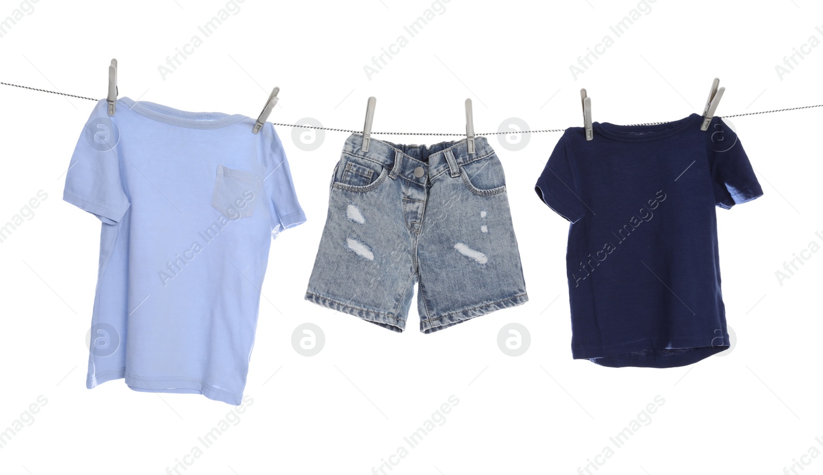 Photo of Different clothes drying on washing line against white background