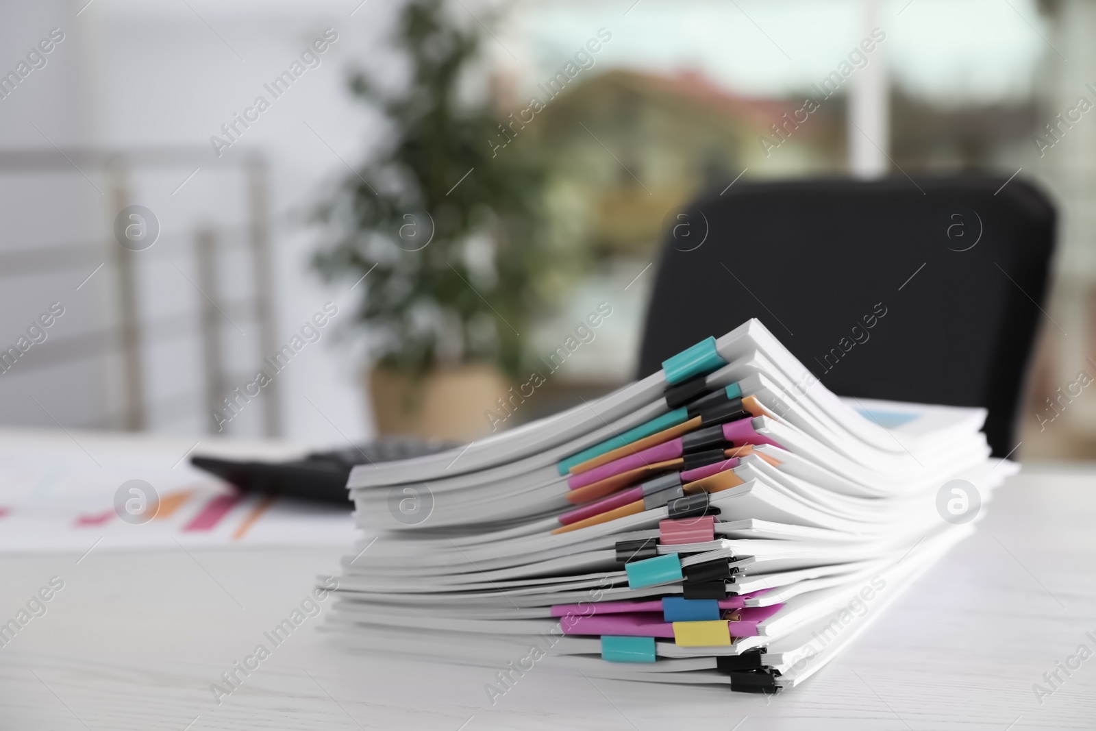 Photo of Stack of documents with paper clips on office table. Space for text