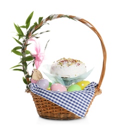 Basket with delicious Easter cake and dyed eggs on white background