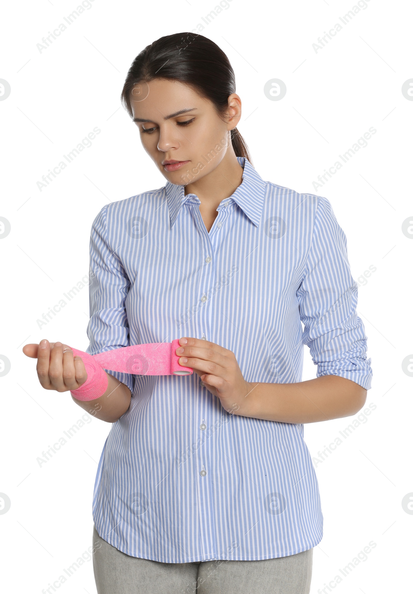 Photo of Young woman with hand wrapped in medical bandage on white background