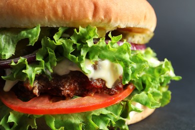 Photo of Delicious burger with beef patty and lettuce on light grey background, closeup