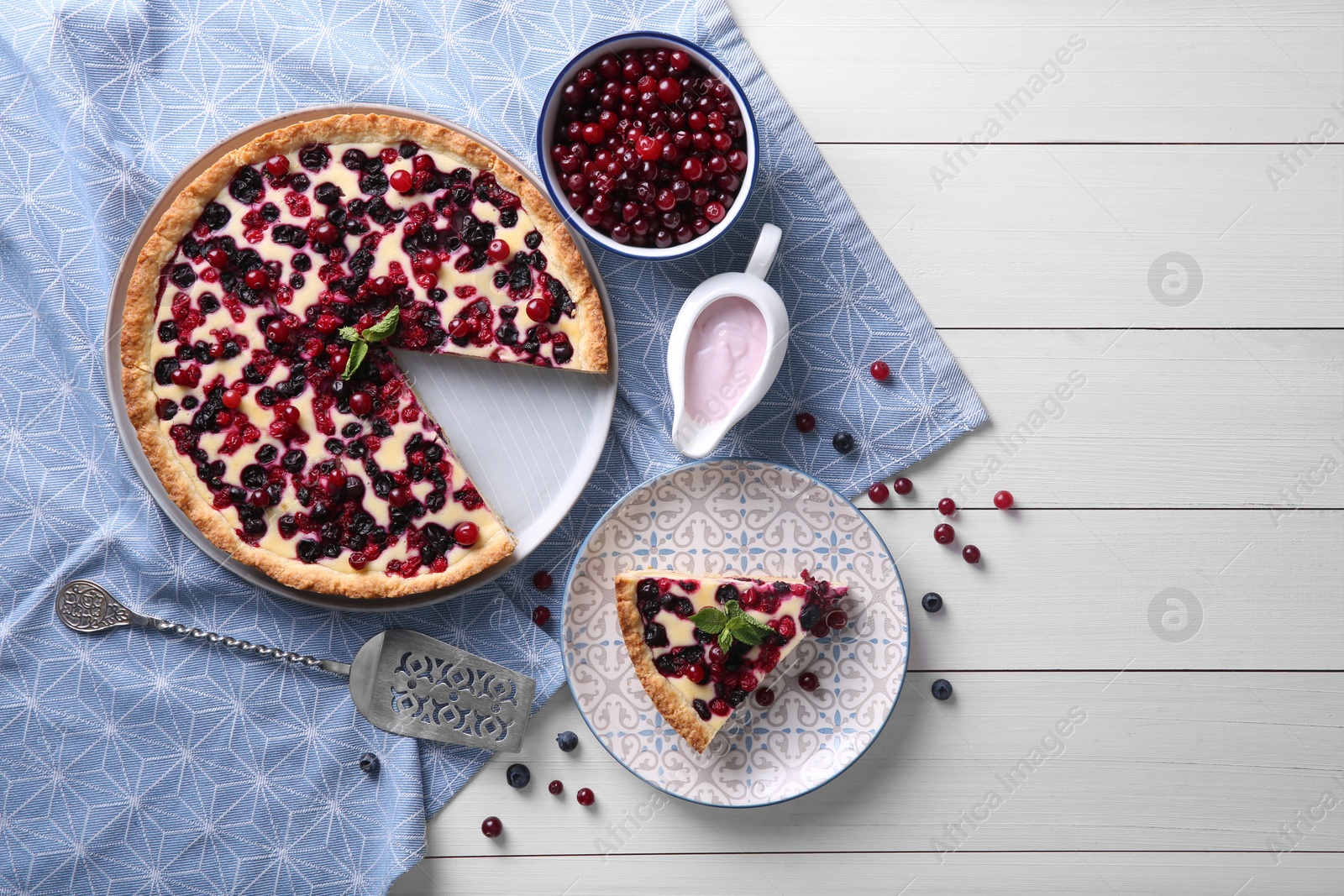 Photo of Delicious currant pie and fresh berries on white wooden table, flat lay. Space for text