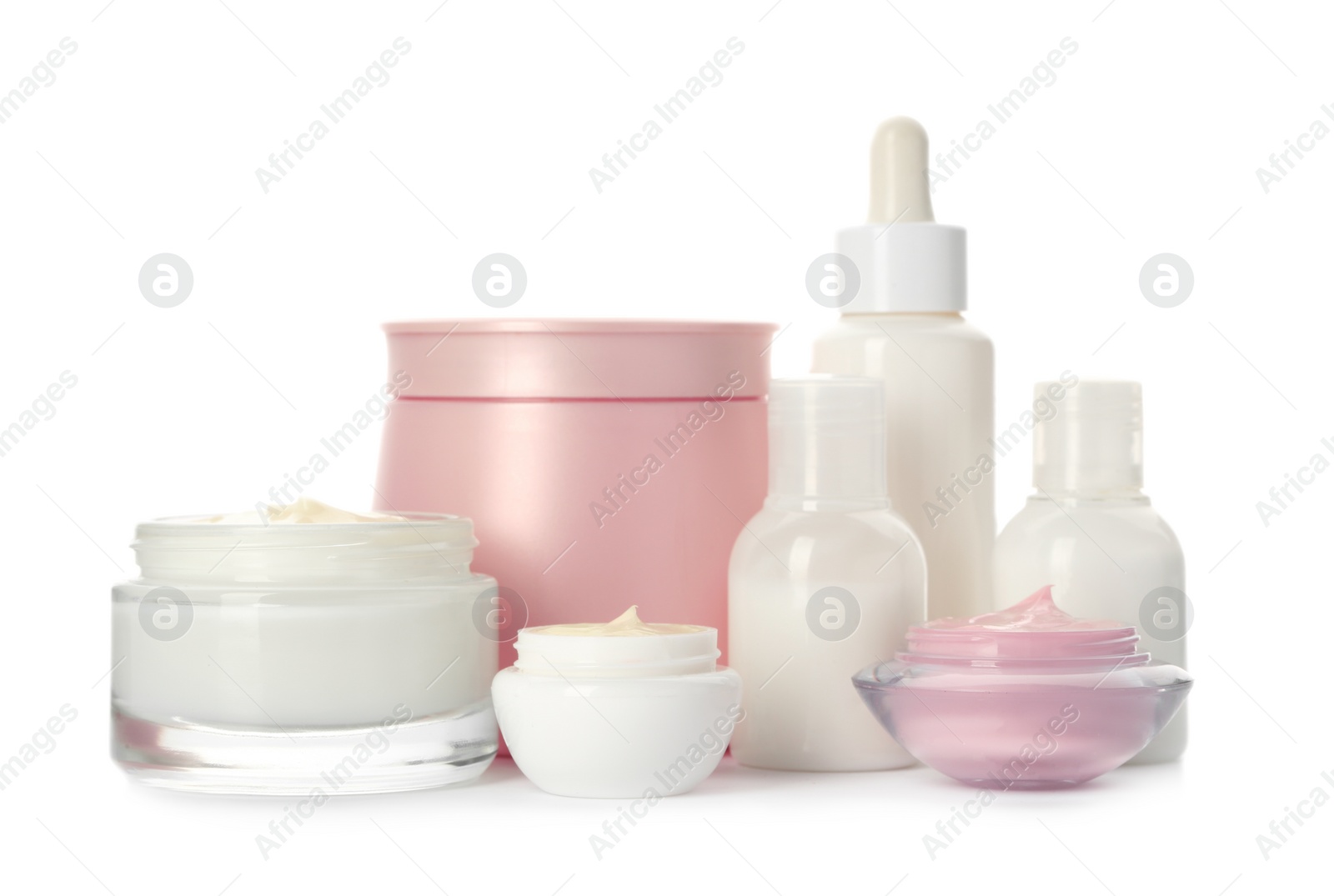 Photo of Different containers with hand cream and other cosmetic on white background