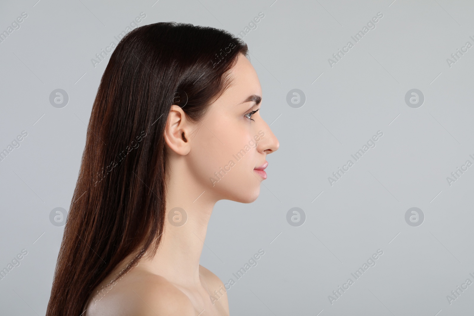 Photo of Beautiful young woman with healthy skin on light grey background. Space for text