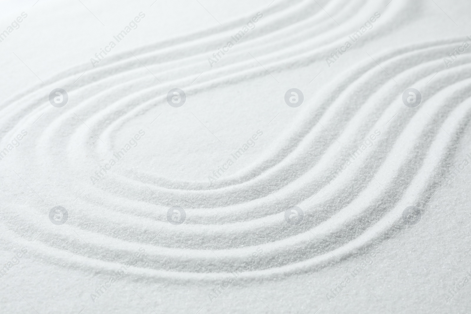 Photo of White sand with pattern as background. Zen, meditation, harmony