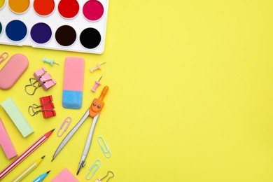 Photo of Flat lay composition with different school stationery on pale yellow background, space for text. Back to school