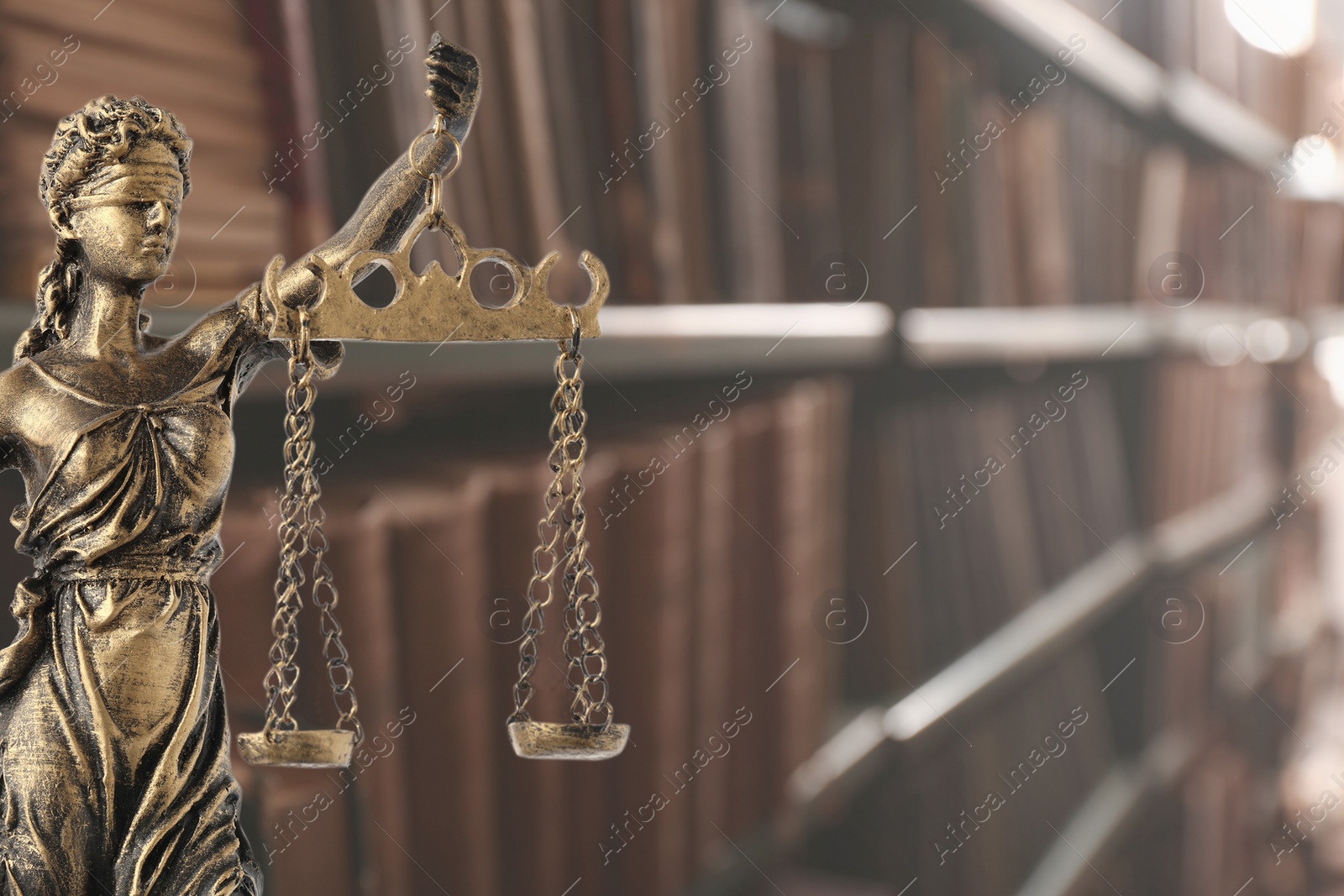 Image of Law and wisdom. Statue of Lady Justice near shelves with books, space for text