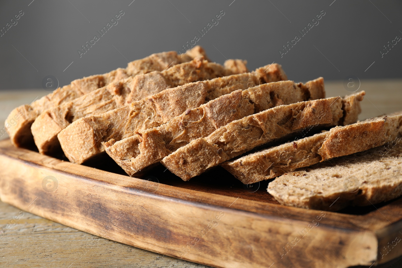 Photo of Freshly baked cut sourdough bread on wooden table, closeup