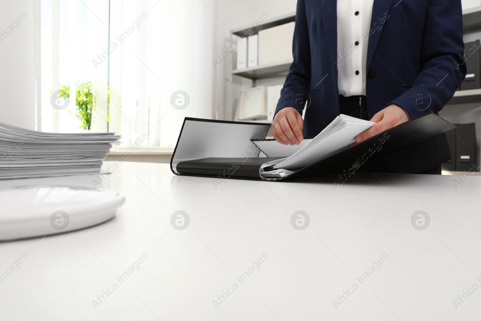 Photo of Woman working with documents at table in office, closeup