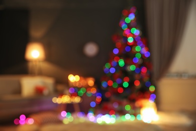 Photo of Blurred view of stylish room interior with decorated Christmas tree