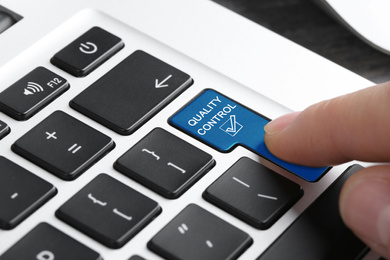 Image of Woman pressing quality control button on computer keyboard, closeup