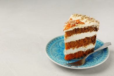 Photo of Plate with piece of carrot cake on light table, space for text