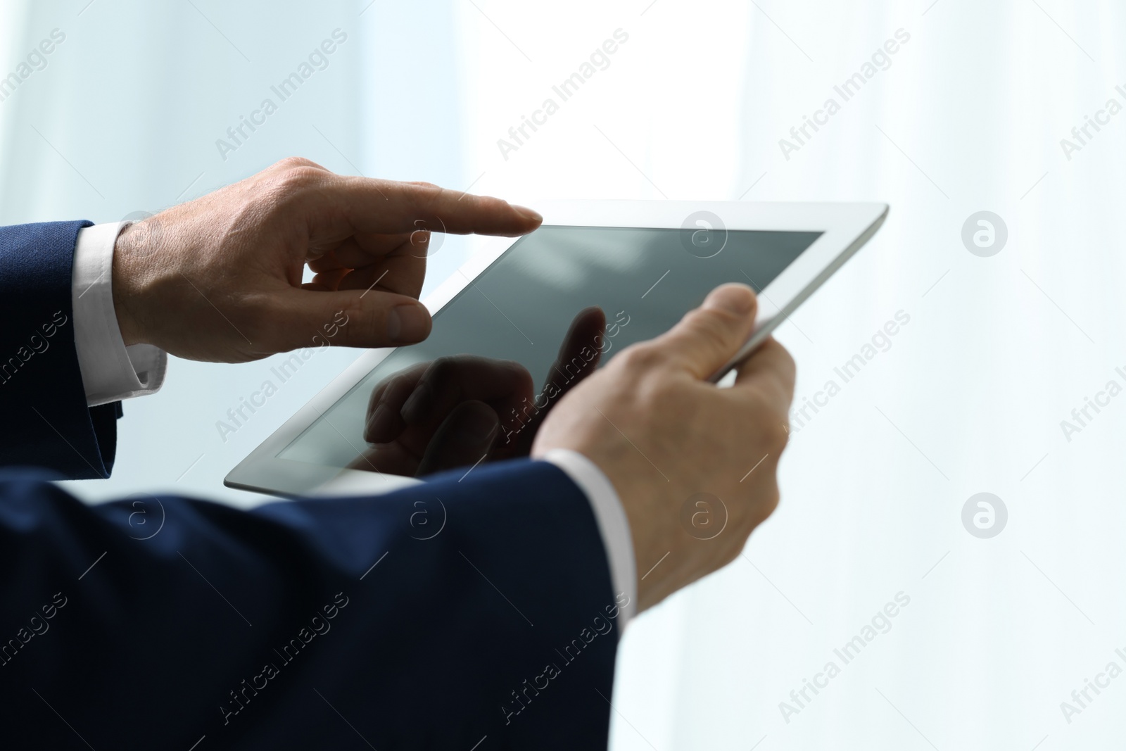 Photo of Closeup view of man using new tablet indoors