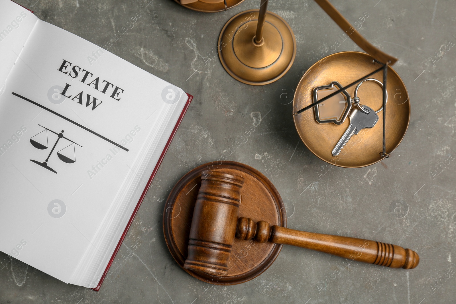 Photo of Flat lay composition with book, gavel, house key and scales of justice on grey background. Estate law concept