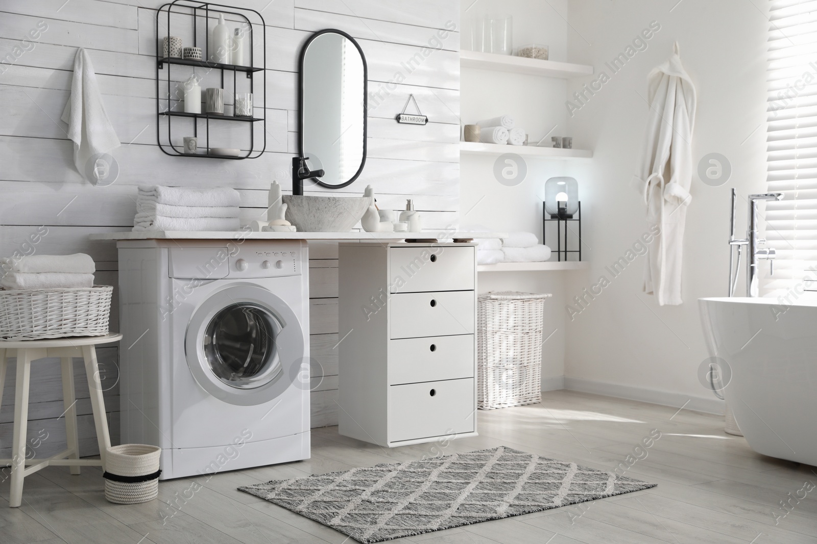 Photo of Stylish bathroom interior with modern washing machine