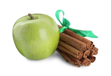 Photo of Cinnamon sticks and green apple on white background