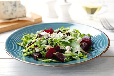 Fresh delicious beet salad on white wooden table