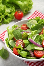 Delicious vegetable salad on light grey table