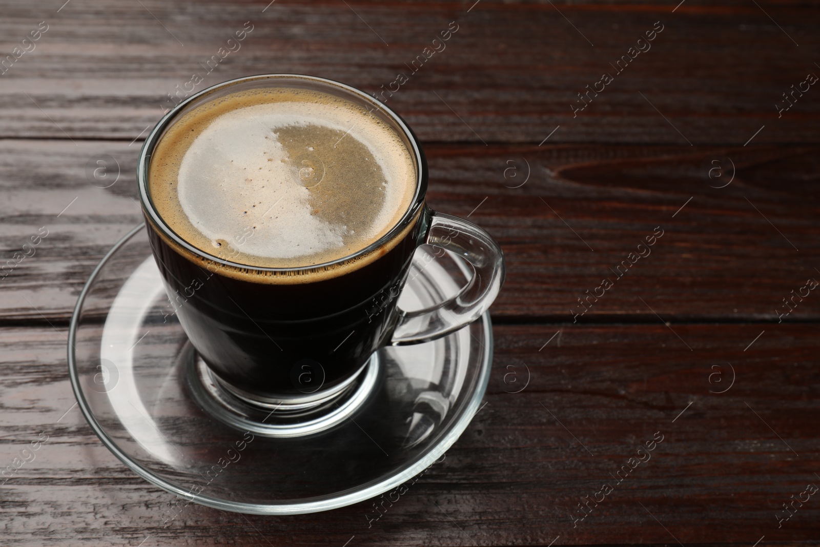 Photo of Cup of aromatic coffee on wooden table, closeup. Space for text