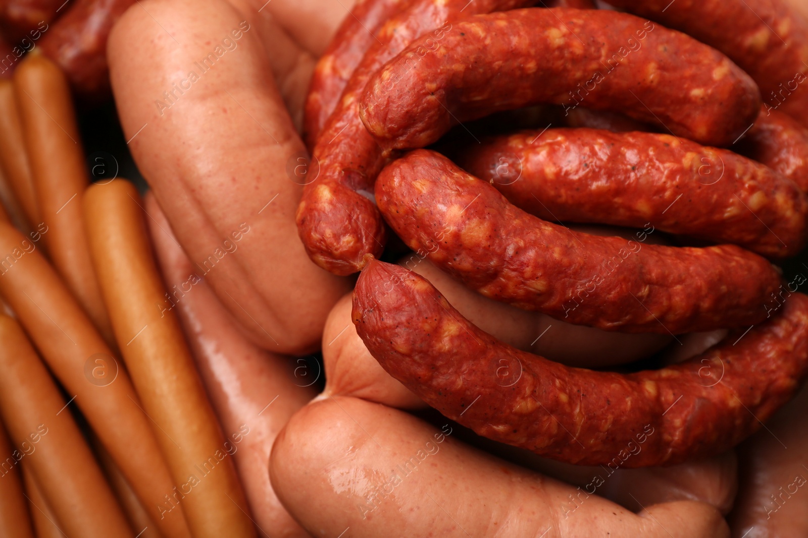 Photo of Different tasty sausages as background, closeup view