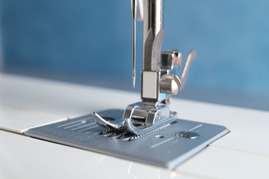 White sewing machine on light background, closeup