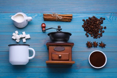 Flat lay composition with vintage manual coffee grinder and spices on light blue wooden background